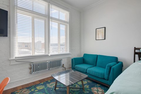 a living room with a blue couch and a table